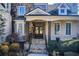 Inviting front porch with stone steps, dark wooden door and decorative columns at 171 Johnson Ferry Nw Rd, Atlanta, GA 30328