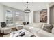 Bright living room featuring a large sectional sofa, a modern chandelier, and lots of natural light at 171 Johnson Ferry Nw Rd, Atlanta, GA 30328