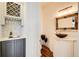 Elegant powder room featuring a vessel sink, decorative mirror, and a wine storage at 171 Johnson Ferry Nw Rd, Atlanta, GA 30328