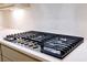 Stainless steel gas cooktop with five burners and white quartz countertop at 6420 Maddux Path, Cumming, GA 30028