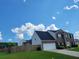 House with brick and vinyl siding, a two-car garage, and a fenced backyard at 74 Windsor Way, Riverdale, GA 30274