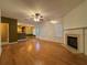 Open living room with hardwood floors, fireplace and ceiling fan at 74 Windsor Way, Riverdale, GA 30274