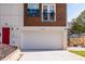 Attached garage with modern white door and red front door at 165 Mayson Ne Ave # A, Atlanta, GA 30307