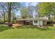 Spacious backyard featuring a wooden deck, screened porch, and mature landscaping around the home at 2947 Dunnington Cir, Chamblee, GA 30341