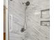 Elegant shower with marble tiling, rainfall shower head, and convenient shelving at 2947 Dunnington Cir, Chamblee, GA 30341