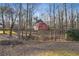Charming red home surrounded by serene wooded grounds, offering a tranquil and private setting at 3970 Bridgeman Cir, Cumming, GA 30041