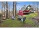 Charming backyard with a fire pit area, overlooking a beautifully constructed red barn-style building at 3970 Bridgeman Cir, Cumming, GA 30041