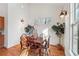Charming dining room with warm lighting, wood accents, and views from multiple windows at 3970 Bridgeman Cir, Cumming, GA 30041