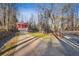 Stunning property featuring a long driveway leading to a red three-car garage at 3970 Bridgeman Cir, Cumming, GA 30041