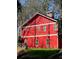 Side angle of a red barn-style building with lots of windows at 3970 Bridgeman Cir, Cumming, GA 30041