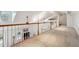 Well-lit hallway overlooking the living area and backyard at 3970 Bridgeman Cir, Cumming, GA 30041
