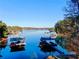 Picturesque lake view featuring private docks, boat slips, and serene waterfront scenery at 3970 Bridgeman Cir, Cumming, GA 30041
