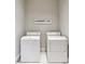 Clean laundry room featuring white appliances and minimal decor at 3970 Bridgeman Cir, Cumming, GA 30041