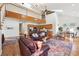 Open concept living space with hardwood floors, staircase to loft area, and a view of the kitchen at 3970 Bridgeman Cir, Cumming, GA 30041