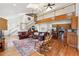 Open concept living space with hardwood floors, staircase to loft area, and a view of the kitchen at 3970 Bridgeman Cir, Cumming, GA 30041