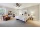 Spacious main bedroom features neutral tones, carpet, and large windows for natural light at 3970 Bridgeman Cir, Cumming, GA 30041