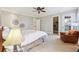 Bright main bedroom featuring a ceiling fan, sitting area, and an ensuite bathroom at 3970 Bridgeman Cir, Cumming, GA 30041