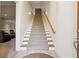 Carpeted staircase featuring a wooden handrail and ample lighting at 3970 Bridgeman Cir, Cumming, GA 30041