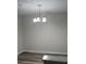 Bright dining room with chandelier and wood-look floors at 6101 Waldrop Pl, Decatur, GA 30034