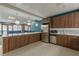 Modern community kitchen with wood cabinets and white counters at 620 Peachtree Ne St # 1815, Atlanta, GA 30308