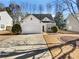 House exterior featuring a white vinyl sided home with a stone accent and a two-car garage at 508 Kensington Park Dr, Canton, GA 30114