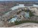 Aerial view shows the pool, lake, tennis courts, and surrounding landscape at 535 Crested Hawk Rdg, Canton, GA 30114