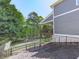 A well-manicured backyard features a deck, ample trees, and a wooden fence at 535 Crested Hawk Rdg, Canton, GA 30114