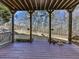 A backyard deck offers outdoor seating with a tranquil view of the well-maintained backyard and surrounding greenery at 535 Crested Hawk Rdg, Canton, GA 30114