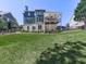 Expansive backyard with a manicured lawn, mature trees, and a covered deck for relaxation at 535 Crested Hawk Rdg, Canton, GA 30114
