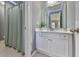 Stylish bathroom with a shower featuring a light green curtain and modern vanity at 535 Crested Hawk Rdg, Canton, GA 30114