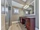 Bathroom featuring a large mirror, walk-in shower, and granite countertops at 535 Crested Hawk Rdg, Canton, GA 30114