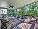 Spacious covered deck featuring wicker furniture, ceiling fan, and outdoor grill at 535 Crested Hawk Rdg, Canton, GA 30114