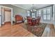 Formal dining room featuring hardwood floors, wainscoting, and elegant chandelier at 535 Crested Hawk Rdg, Canton, GA 30114