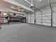 Large garage features car lift, bright lighting, and multiple garage doors at 535 Crested Hawk Rdg, Canton, GA 30114