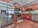 Modern kitchen boasts stainless steel appliances, dark wood cabinets, and tiled backsplash, perfect for cooking at 535 Crested Hawk Rdg, Canton, GA 30114