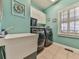 Laundry room with a utility sink and modern appliances at 535 Crested Hawk Rdg, Canton, GA 30114