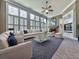 Spacious living room with large windows, cozy fireplace, plush seating, and classic decor, bathed in natural light at 535 Crested Hawk Rdg, Canton, GA 30114