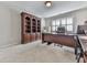 Cozy office space with carpet, built-in shelves, and a desk at 535 Crested Hawk Rdg, Canton, GA 30114