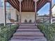 Covered patio features wooden beams, brick walls, and a staircase, perfect for enjoying the outdoors at 535 Crested Hawk Rdg, Canton, GA 30114