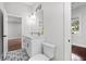 Modern bathroom with double vanity, patterned floor, and view to bedroom at 774 Tift Sw Ave, Atlanta, GA 30310