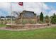 Stone entrance sign for Auburn Ridge community surrounded by landscaping at 8194 Tiger Way, Riverdale, GA 30296