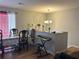 Cozy dining room featuring a table, chairs, piano, decorative chandelier, and wood-look vinyl flooring at 992 Brian Ln, Forest Park, GA 30297
