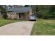 Charming two-story home with a well-maintained lawn and modern SUV parked in the driveway at 992 Brian Ln, Forest Park, GA 30297