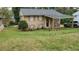 Two-story home with a covered carport, a well-manicured lawn, and mature trees enhancing its curb appeal at 992 Brian Ln, Forest Park, GA 30297