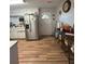 Charming kitchen features white cabinets, modern stainless steel appliances, and wood-look vinyl flooring at 992 Brian Ln, Forest Park, GA 30297