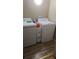 Functional laundry area features a washer, dryer, and utility sink on durable vinyl flooring at 992 Brian Ln, Forest Park, GA 30297
