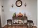 Stylish Living room highlighting a rustic table with stools, decorative candles, plants, and a large clock for ambiance at 992 Brian Ln, Forest Park, GA 30297