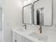 Bathroom featuring double sinks, modern fixtures, and dual mirrors at 1820 Lake Dow Rd, Mcdonough, GA 30252
