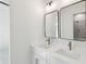 Bathroom featuring double sinks, modern fixtures, and dual mirrors at 1820 Lake Dow Rd, Mcdonough, GA 30252
