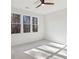 Bright bedroom with a ceiling fan and beautiful views of the trees outside the windows at 1820 Lake Dow Rd, Mcdonough, GA 30252